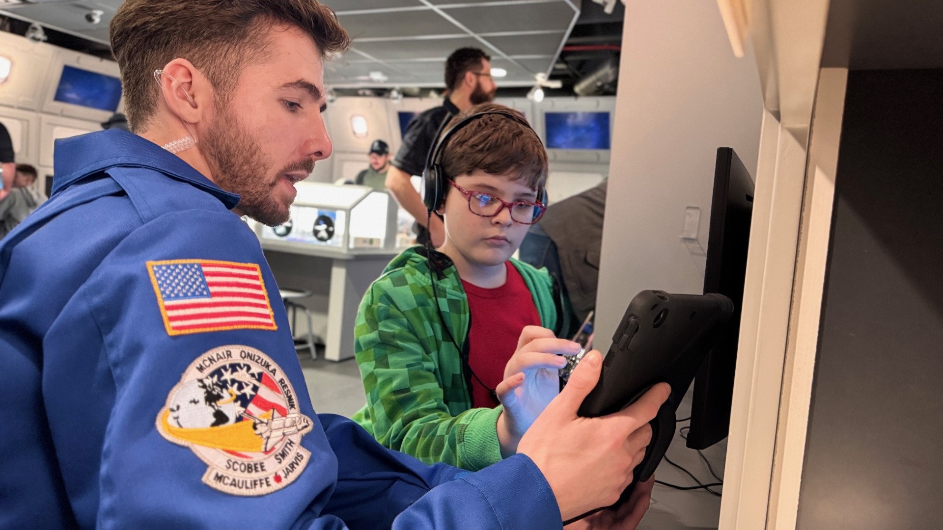 Volunteer and child in Challenger Learning Center
